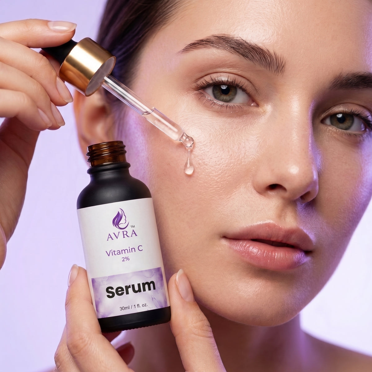 Avra Vitamin C Serum being applied - brightening serum dropper on face